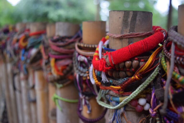 colorful memorial bracelets on fence posts commemorating the victims of the khmer rouge at the killing fields phnom penh cambodia