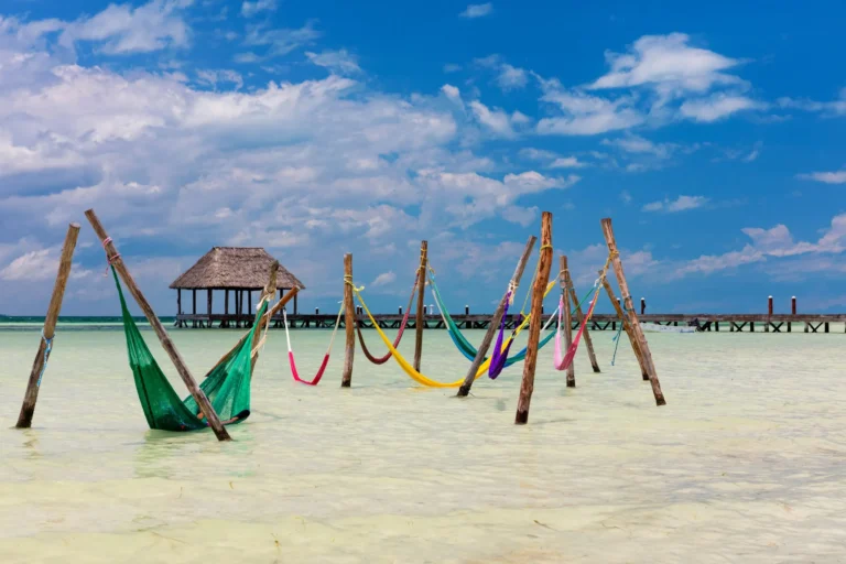 group of colorful hammocks in the water--relaxing here is among the best things to do on isla holbox mexico