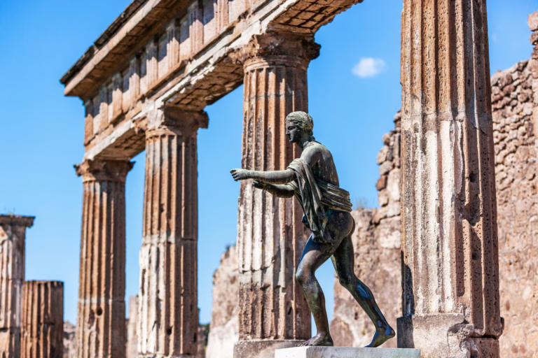 Statue of Apollo in front of the Temple of Apollo in Pompeii. Incredible ruins like this can be seen at either Pompeii or Herculaneum